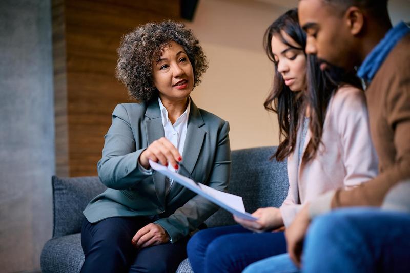 An adviser going through paperwork with a family